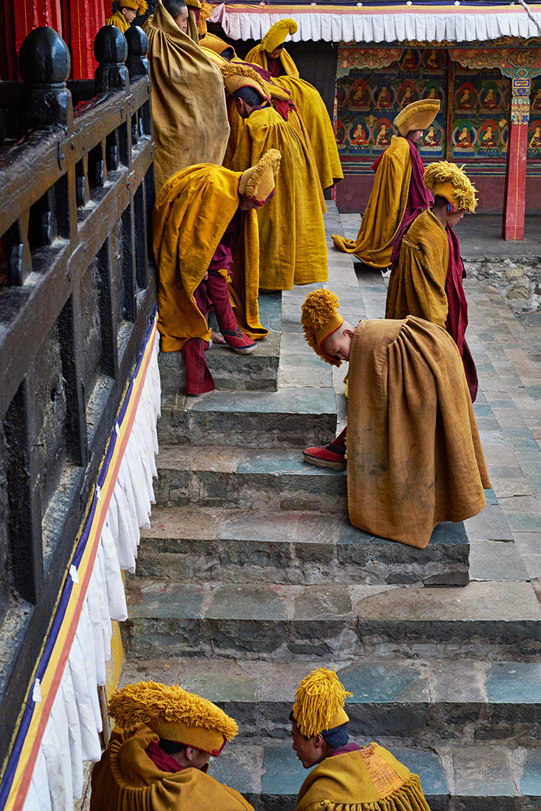 Monks emerge from their quarters and dress for communal chanting, Tashilhunpo Monastery, Shigatse, Tibet