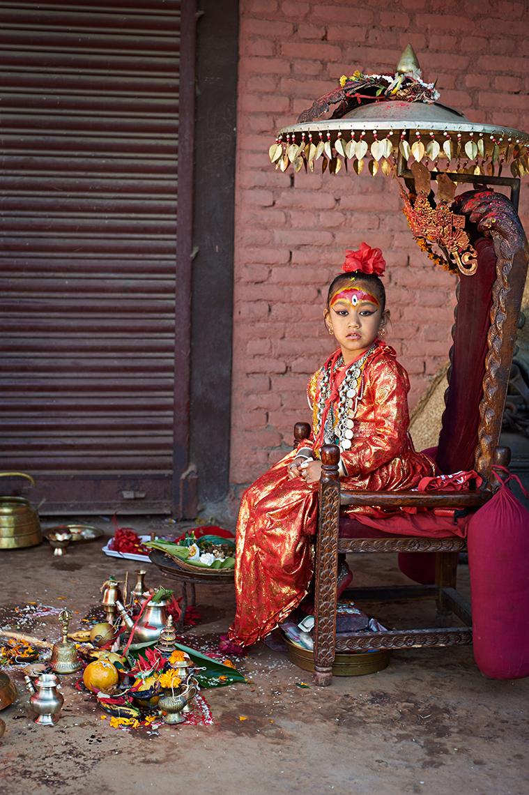 The kumari (living goddess) of Bungamati, Nepal, awaits worshippers seeking her blessings of good fortune
